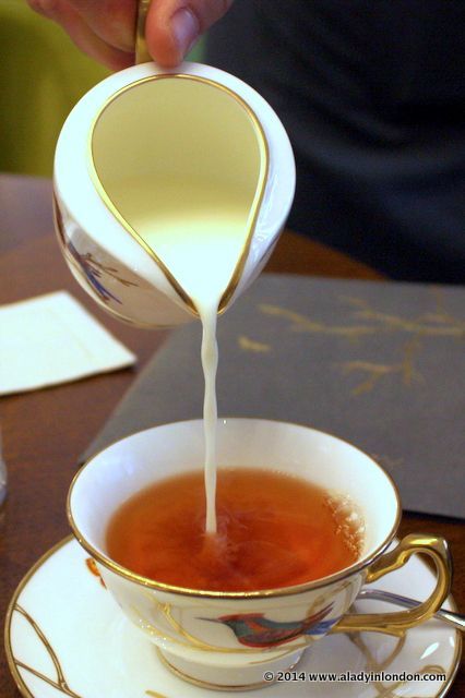 a person pours tea into a cup