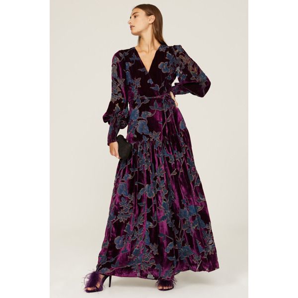 Purple floral velvet (80% Viscose, 20% Nylon). Wrap. Long sleeves. V-neck. Tie closure. 58" from shoulder to hemline. Imported. Velvet Maxi Dress For Fall, Fitted Velvet Maxi Dress For Fall, Velvet V-neck Dress For Fall, Fall Fitted Velvet Maxi Dress, V-neck Velvet Dress For Fall, Floral Print Surplice Neckline Maxi Dress For Evening, Fitted Velvet V-neck Maxi Dress, Winter Evening Dress With Floral Print, Elegant Velvet Maxi Dress For Fall