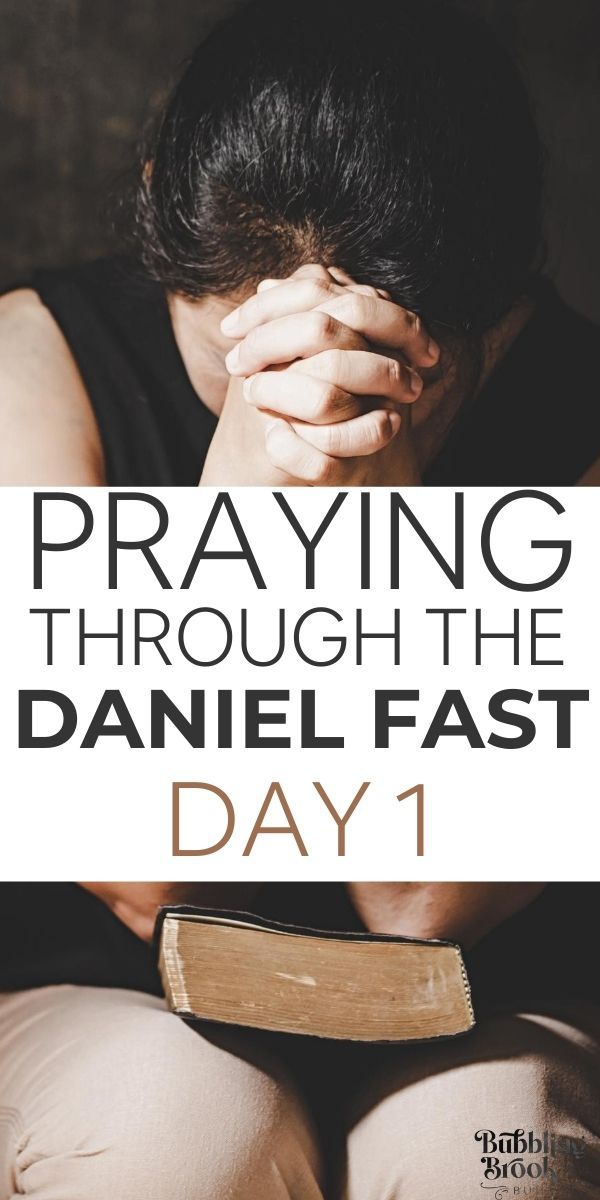 a woman sitting on the ground with her hands over her face and text saying praying through the danielle fast day 1