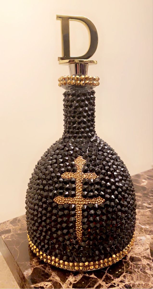 a decorative bottle with a cross on it