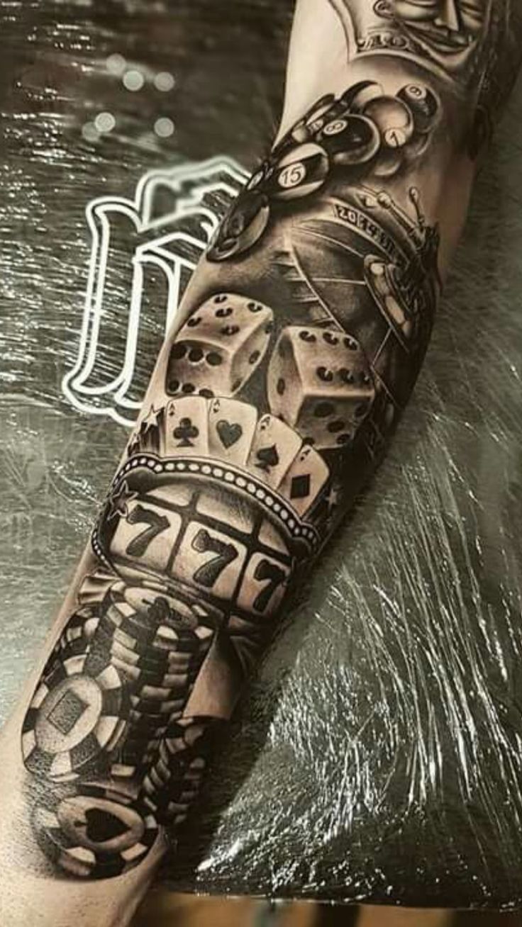 a man's arm with tattoos on it and some dices in the middle