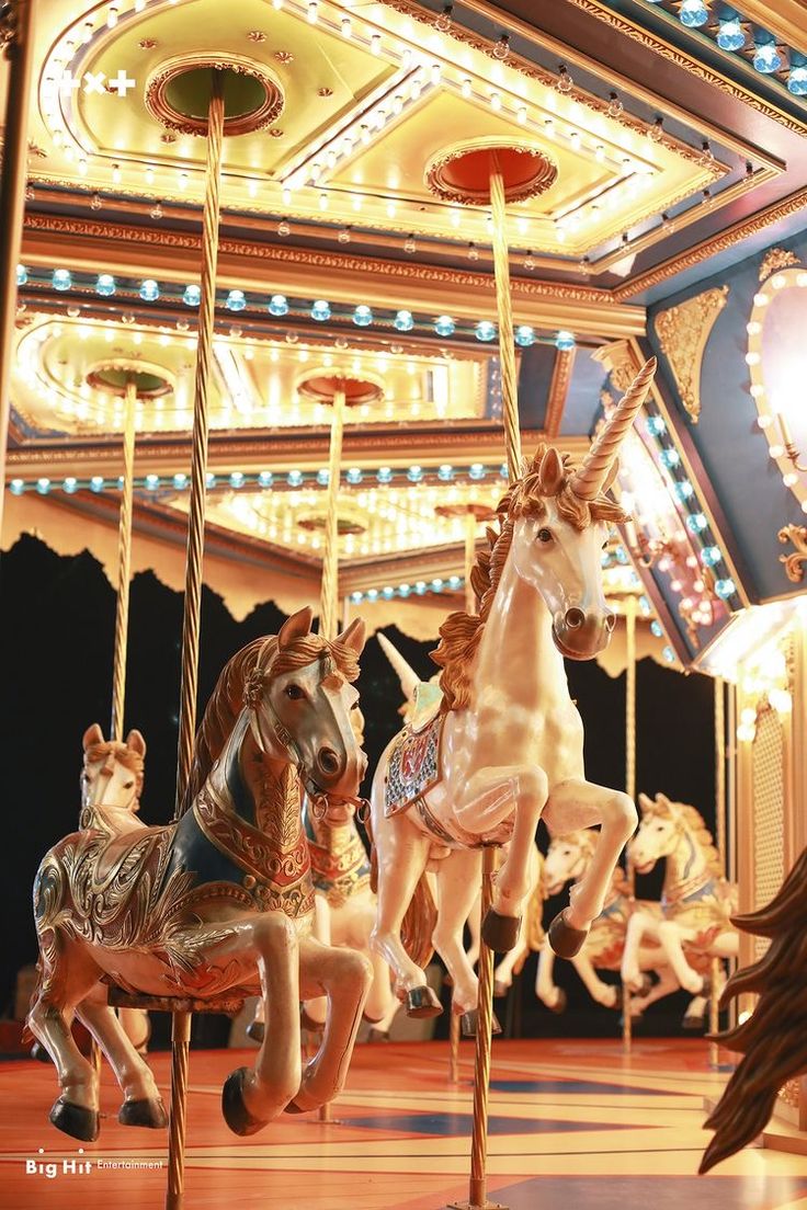 three carousel horses on a merry go round ride