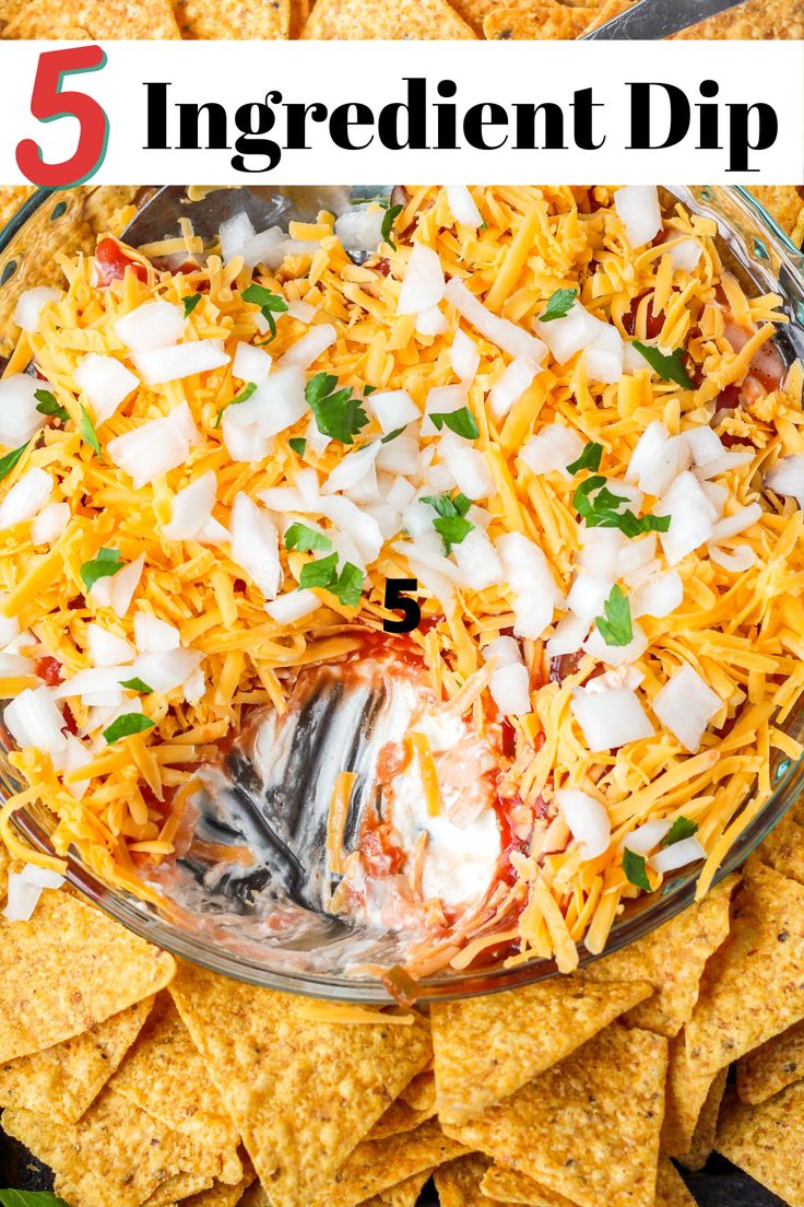 a bowl filled with mexican dip surrounded by tortilla chips