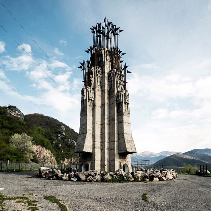 a very tall building sitting in the middle of a field