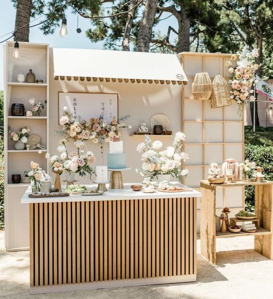 an outdoor bar with flowers and candles on it