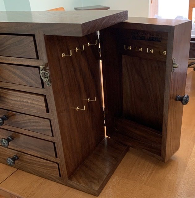 a wooden cabinet with two doors open on the floor