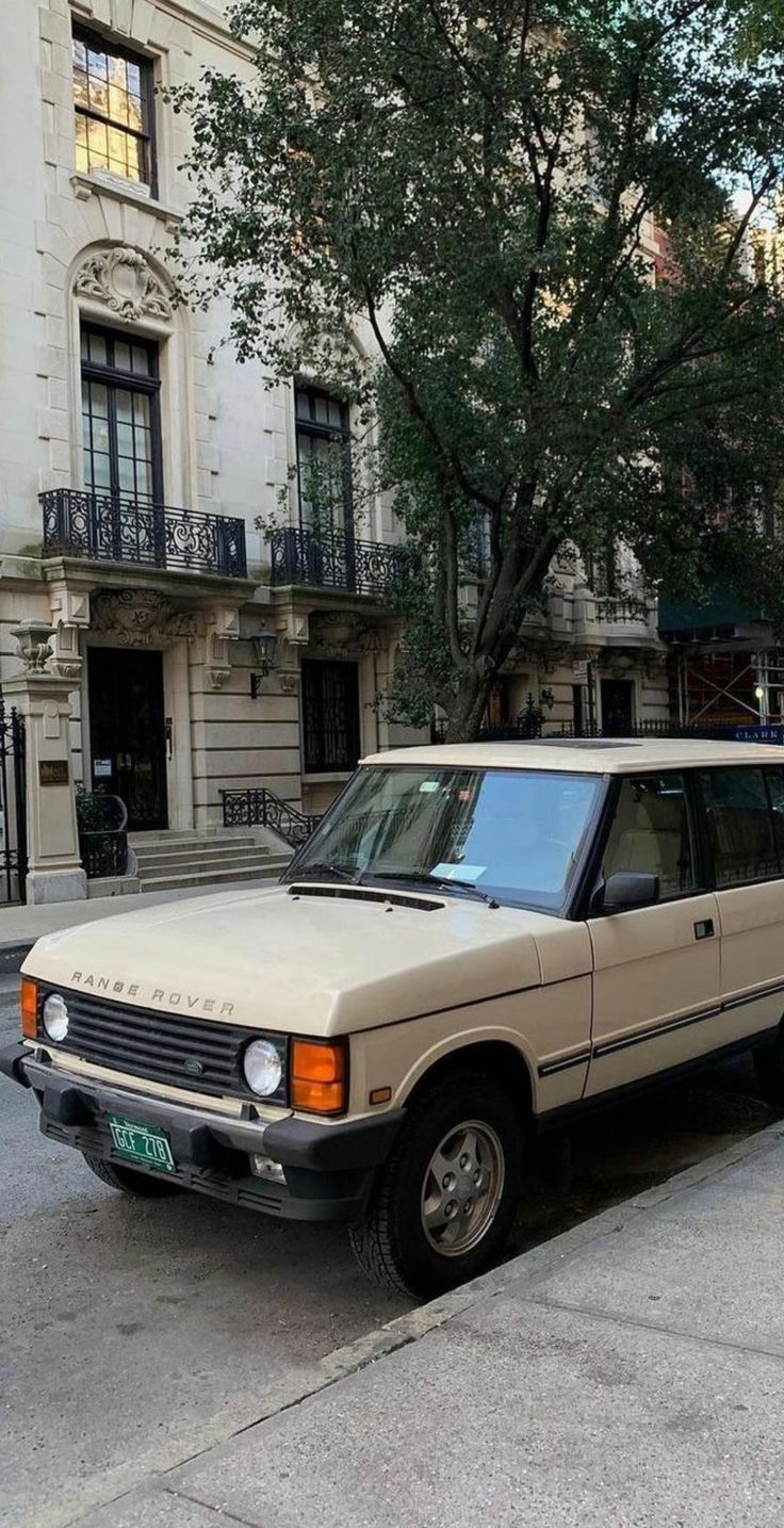 an old car parked on the side of the street