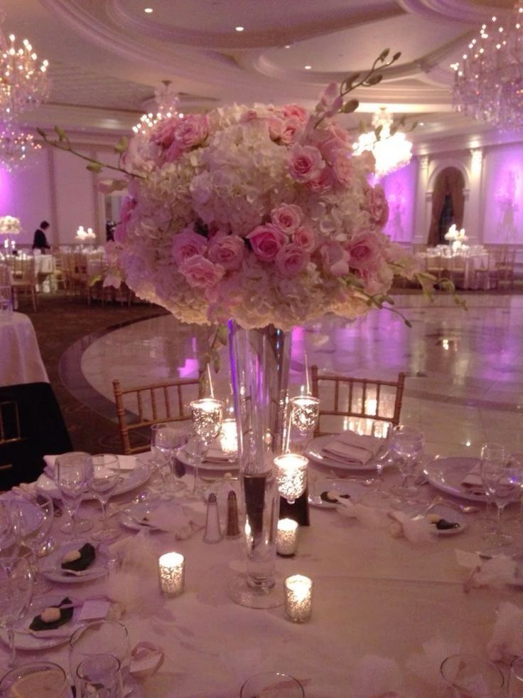 an elegant centerpiece with pink flowers and candles