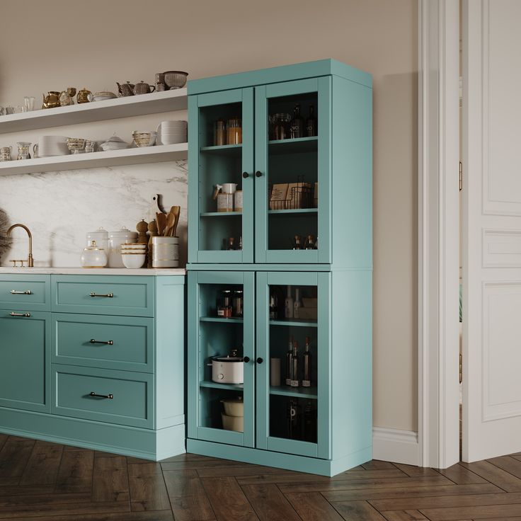 a kitchen with blue cabinets and wooden floors