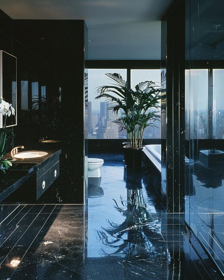 a bathroom with black marble flooring and large windows looking out onto the cityscape