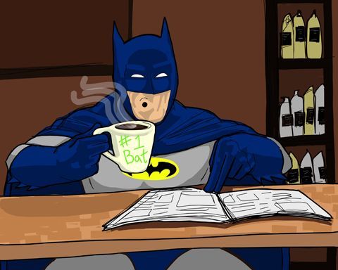 a batman sitting at a table with a cup of coffee