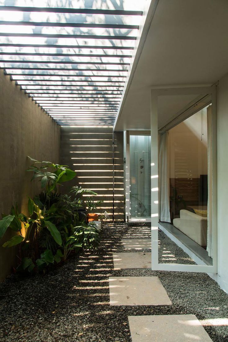 an outdoor area with stairs and plants on the side of the house, along with a glass door that leads to another room