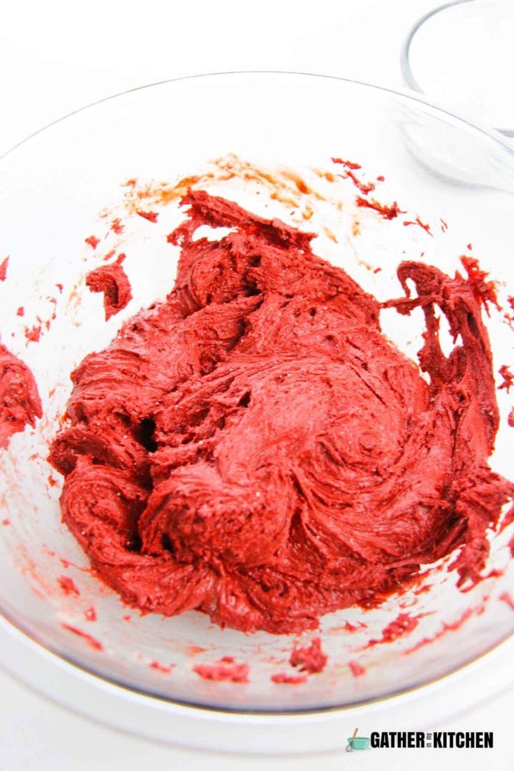 a white plate topped with red cake batter