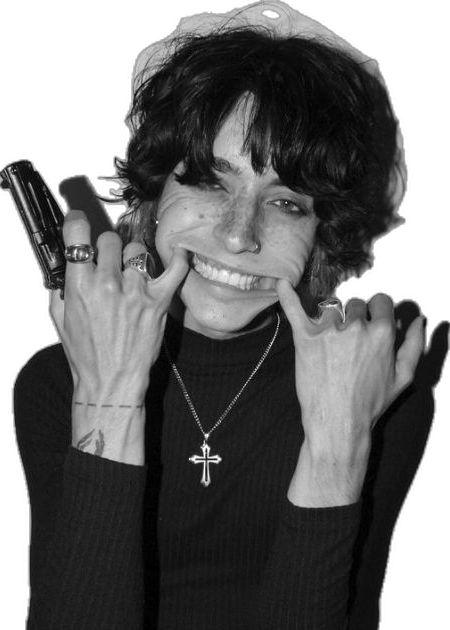 black and white photograph of a woman holding her hands up to her face while smiling