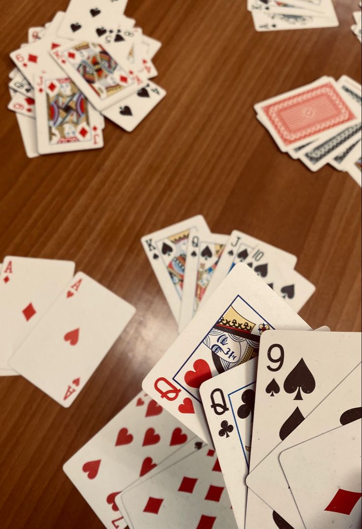 playing cards are scattered on the table and spread out in order to make a big impact