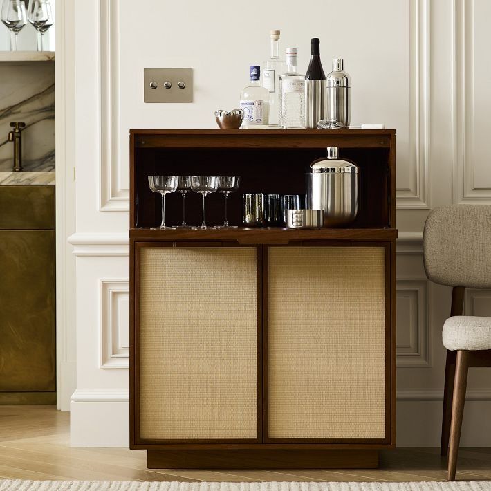 a cabinet with wine glasses and bottles on it