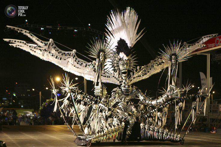 an elaborately decorated float at night with people watching