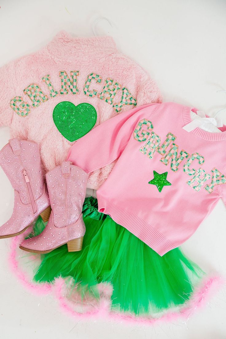 Get ready for some Grinchy fun with our MINI KIDS GRINCHY PINK FUZZY SET! This adorable set features a cozy pink fuzzy material with green and pink checkered Grinchy letters and a green sequin heart patch. Perfect for adding a touch of whimsy to your little one's wardrobe. All orders are currently shipping within 14 business days. To receive item quicker, expedited shipping is available at checkout. **All Christmas orders must be placed with expedited shipping to guarantee delivery by Dec. 24 if Pink And Green Checkered, Pink Grinch, Green Checkered, Pink Checkered, Heart Patch, Heart Patches, Feather Trim, Pink Knit, Pink Feathers