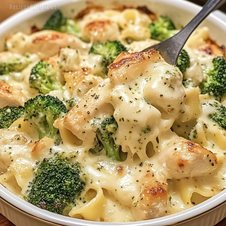 a bowl filled with pasta and broccoli covered in cheese