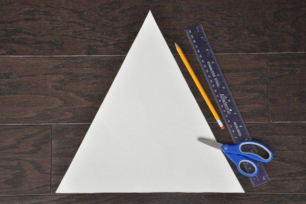 a pair of scissors, ruler and pencil sitting on top of a piece of paper