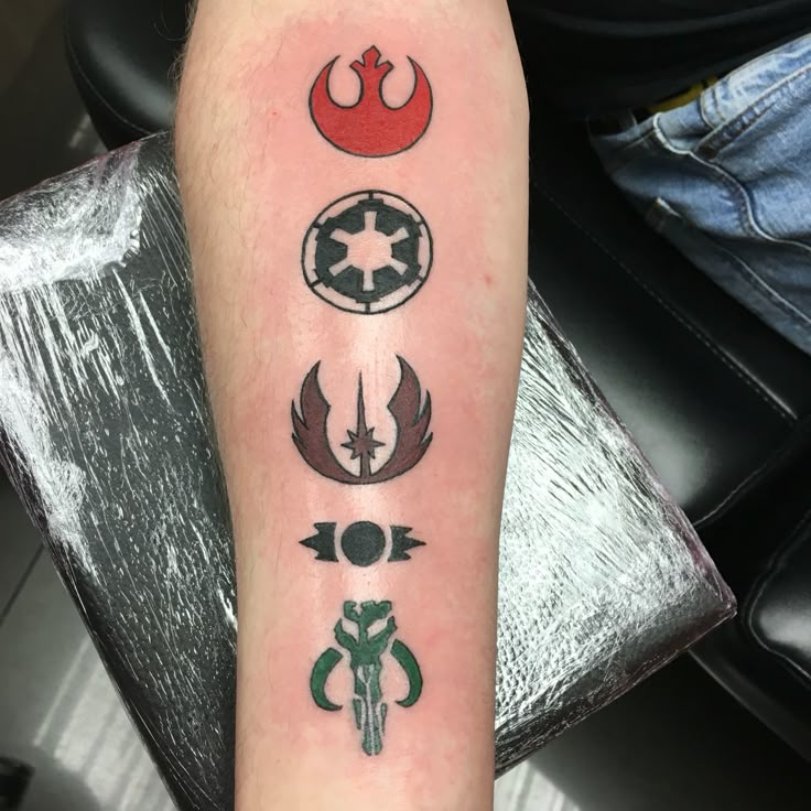 a person with a star wars tattoo on their arm and the other symbols are in different colors