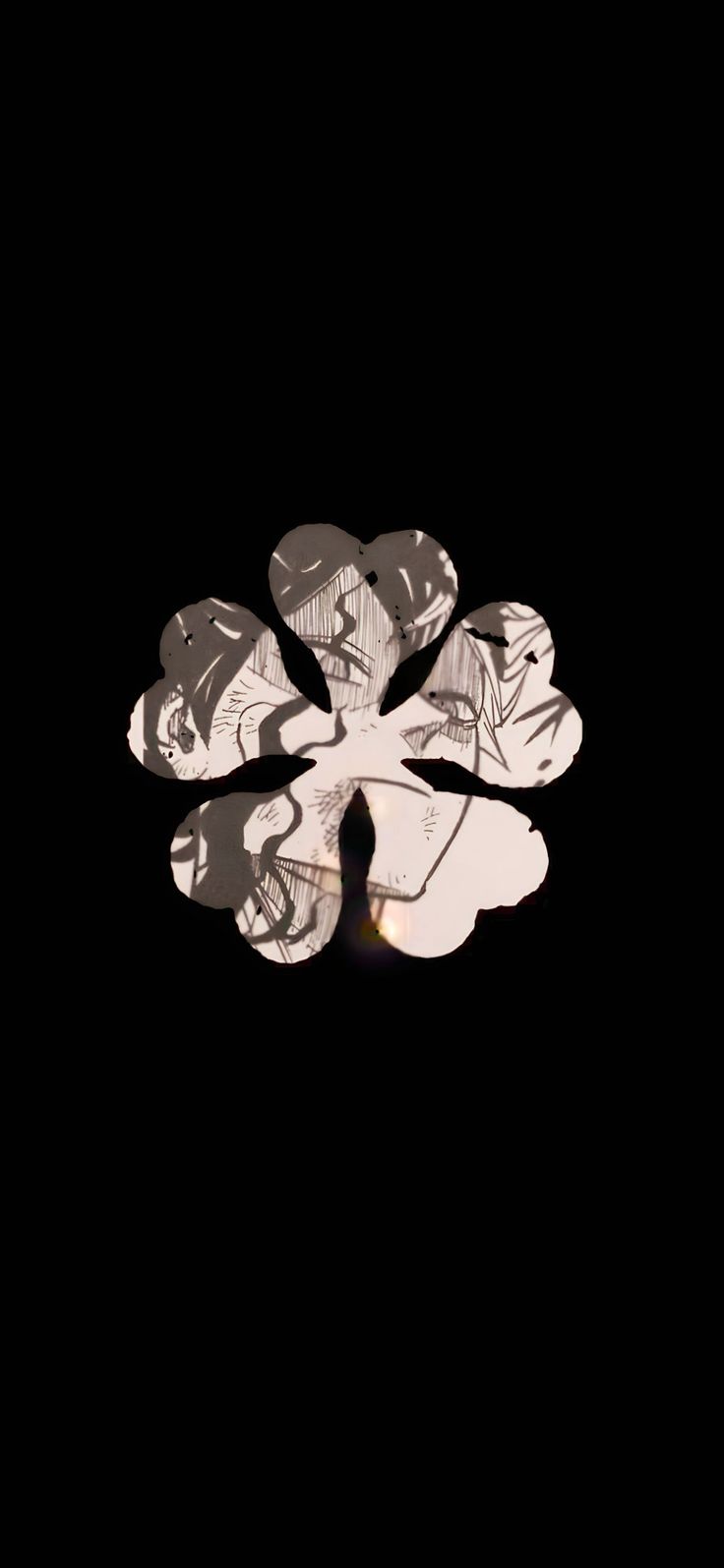 a black and white photo of a flower on a dark background with the light reflecting off it's petals