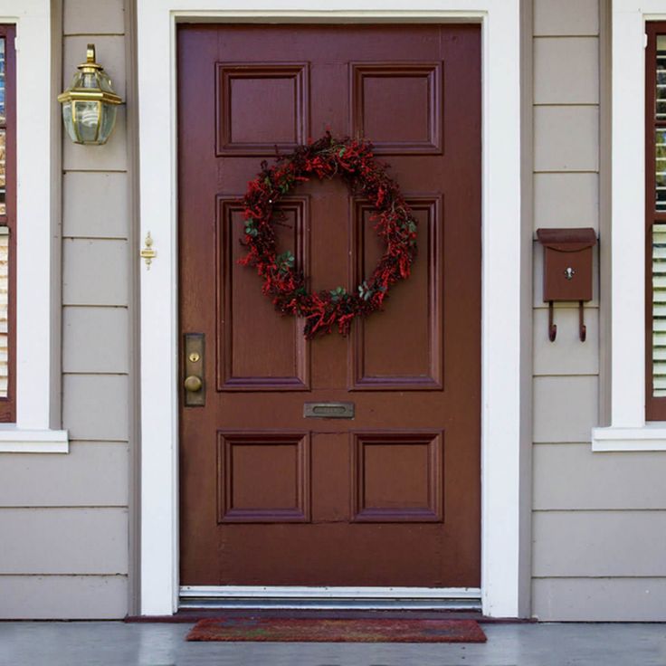 a red door with a wreath on it