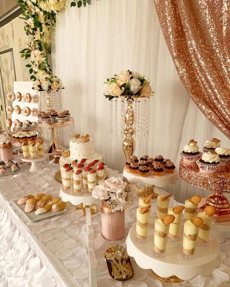 a table topped with lots of cakes and desserts