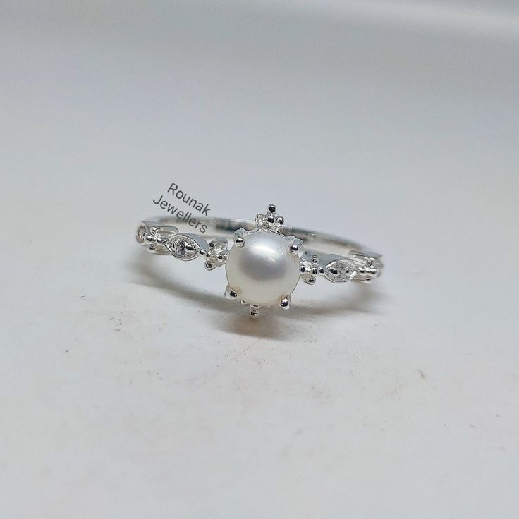 BAND - ROUNAK JEWELLERS MATERIAL - 925 STERLING SILVER GEMSTONE - NATURAL FRESH WATER PEARL PEARL STONE WEIGHT - 1.45 CARAT PEARL STONE SIZE - 6.20 MM SECONDARY STONE - CUBIC ZIRCONIA ZIRCONIA STONE WEIGHT - 0.06 CARAT ZIRCONIA STONE SIZE - 1.20 MM GROSS WEIGHT - 2.780 GM STONE SHAPE - ROUND GEM COLOUR - WHITE RING SIZE - ALL SIZE AVAILABLE PLEASE GIVE YOUR OPENION OR FEEDBACK ABOUT THE PRODUCT. WE ACCEPT BULK ORDER ALSO. https://www.etsy.com/in-en/shop/RounakJewellers?ref=search_shop_redirect White Pearl Promise Ring Stamped 925, Diamond White Sterling Silver Pearl Ring Gift, Stamped 925 Pearl Ring For Wedding, Wedding Pearl Ring Stamped 925, Adjustable White Gold Pearl Ring In Sterling Silver, Gift Diamond White Pearl Ring In Sterling Silver, Dainty Sterling Silver Pearl Ring For Anniversary, Silver Sterling Silver Pearl Ring For Wedding, Wedding Pearl Ring Stamped 925 In Sterling Silver