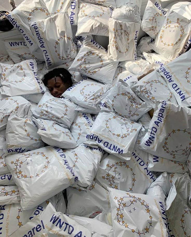 a pile of white bags sitting on top of each other in front of a person