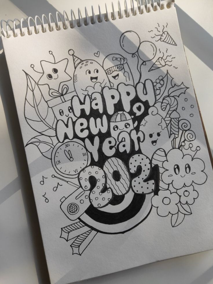 a spiral notebook with the words happy new year on it