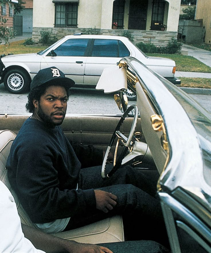 a man sitting in the driver's seat of a car