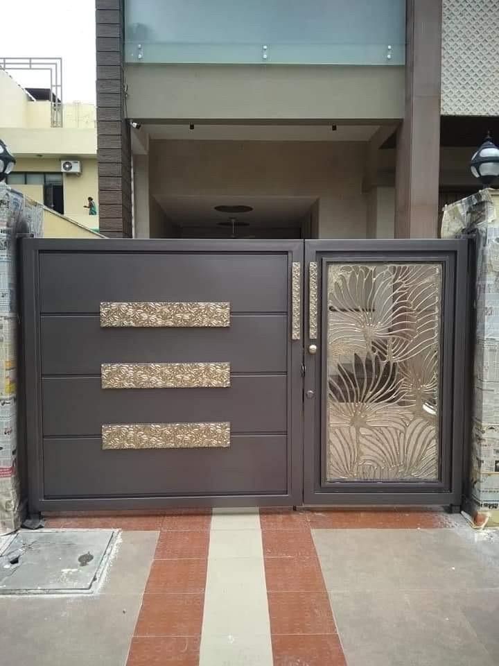 an iron gate with decorative glass panels on it