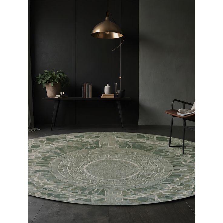 a round rug in the middle of a room with a chair and table behind it