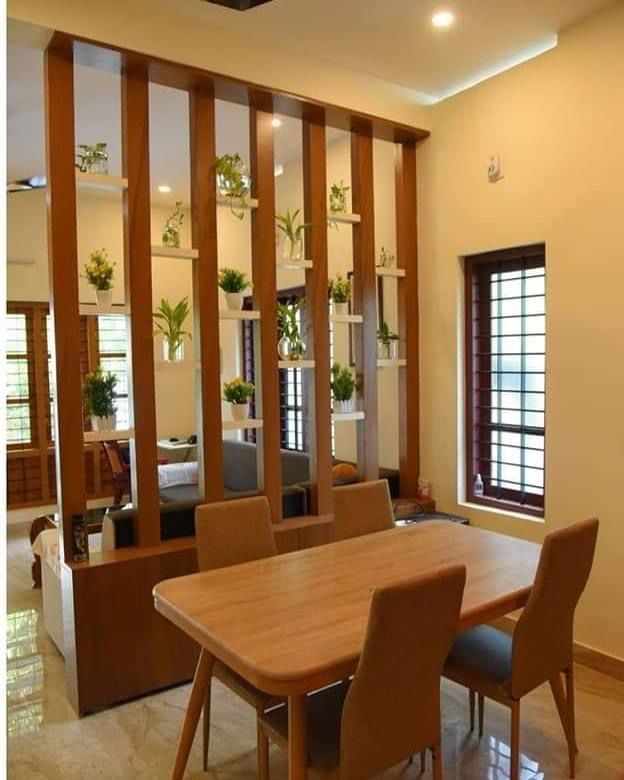 a table and chairs in a room with wooden partitions on the wall behind them