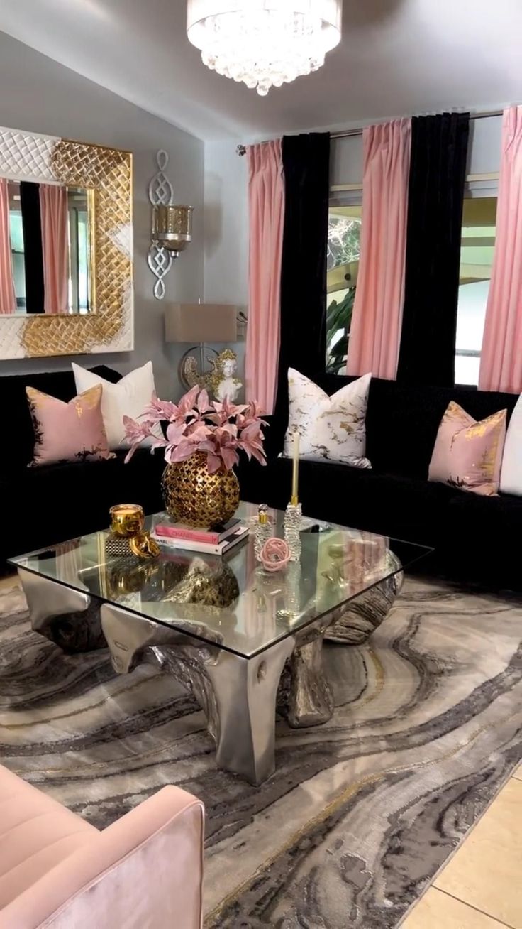 a living room filled with furniture and pink curtains