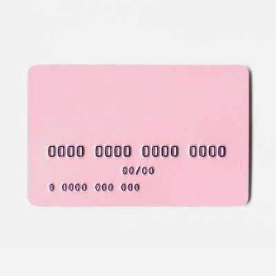 a pink credit card sitting on top of a white table