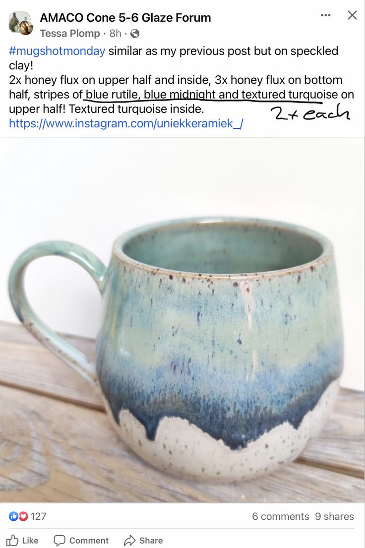 a blue and white mug sitting on top of a wooden table