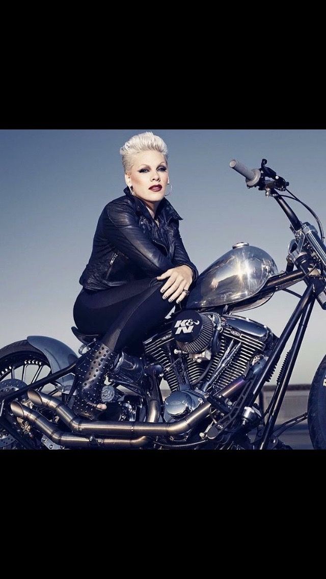 a woman sitting on top of a motorcycle