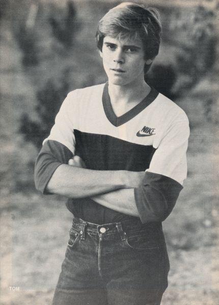 an old black and white photo of a man with his arms crossed in front of him