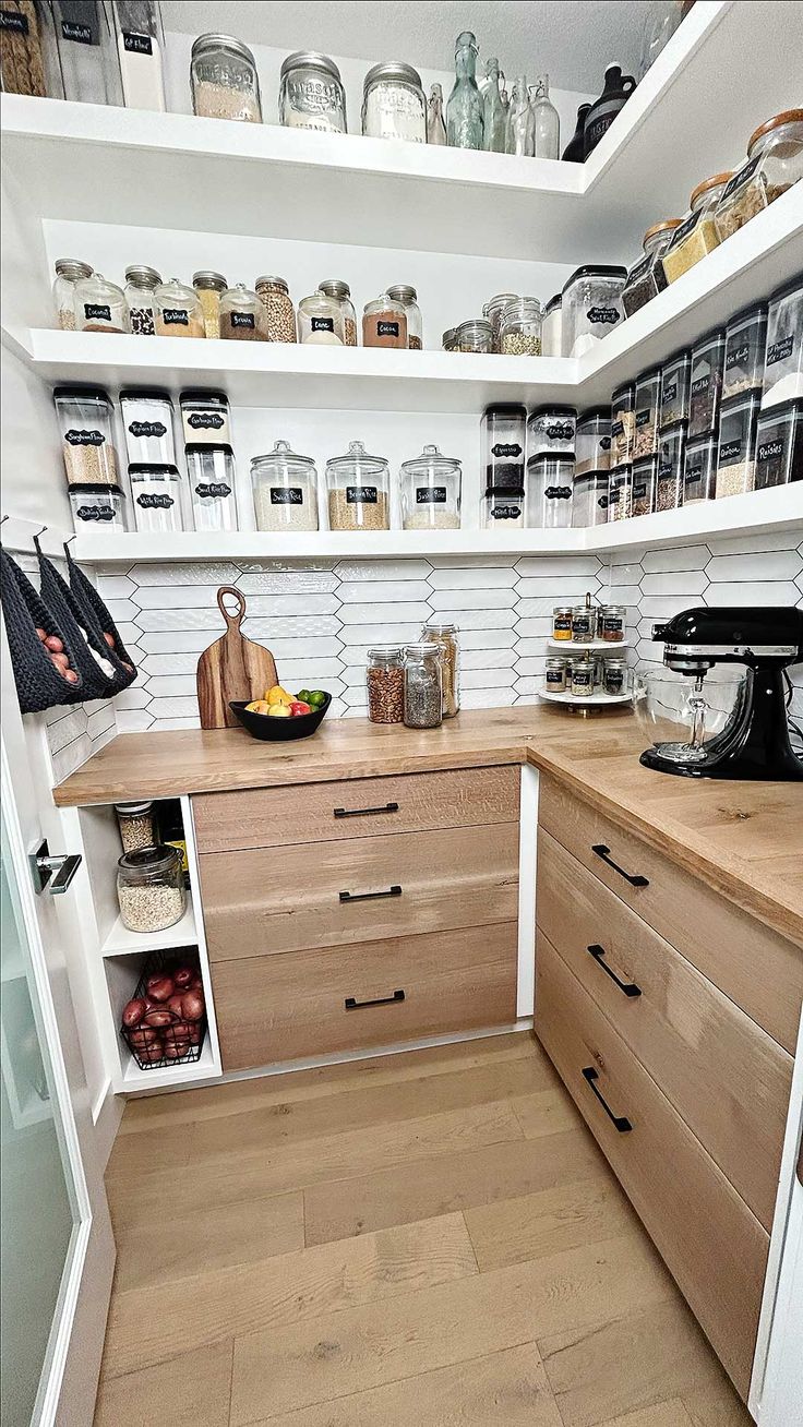 a kitchen with wooden cabinets and white shelves