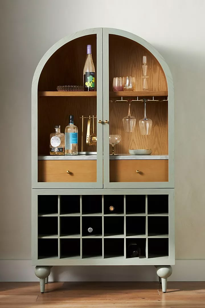 a cabinet with wine glasses and bottles in it