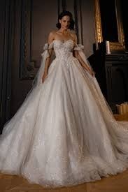 a woman in a wedding dress is posing for the camera