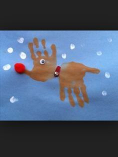 a handprint with a red ball on it in the shape of a reindeer's head