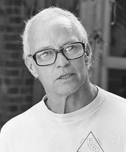 an old man wearing glasses and a t - shirt with a triangle design on it