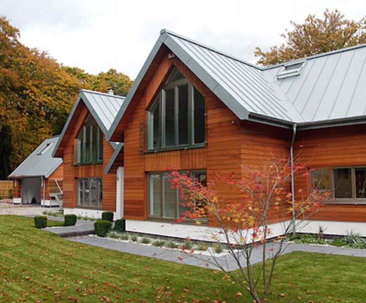 a wooden house with metal roofing and windows