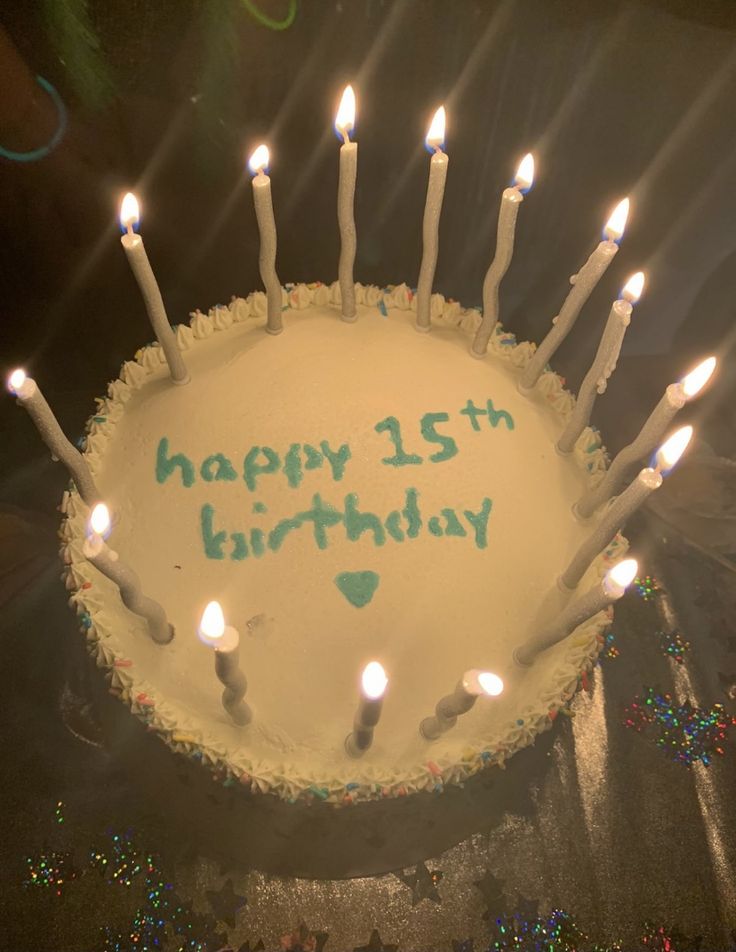 a birthday cake with lit candles on it