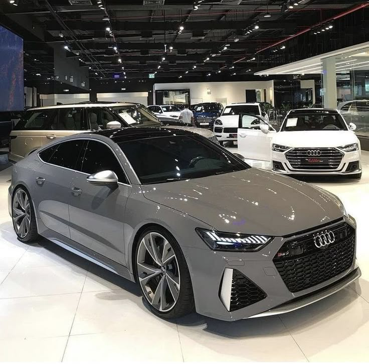 an audi car is on display at the showroom with other cars in the background