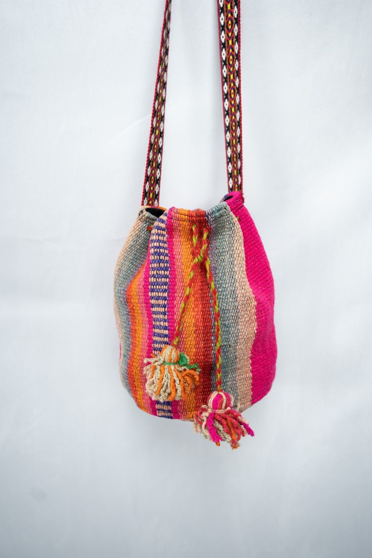 This beautiful handwoven sheep wool Handbags, aptly named the Franco, is not just a bag; it's a testament to the spirit of the Andean culture and the rich history of Peru. Made with unwavering dedication, courage, and love, this shoulder handbags is a tangible piece of artistry that encapsulates the essence of Andean heritage. This women's Handbags purse has been woven by skilled Andean hands, creating a mesmerizing tapestry that embodies centuries of tradition. Dyed using only organic and natural products, the Franco handbag is a sustainable masterpiece that echoes the deep-rooted connection between the artisans and their environment. As you hold this handbag, you hold a piece of Cuzco's legacy, where the magnificent Machu Picchu stands as a testament to the grandeur of the Andean world. Square Woven Bags For Daily Use, Daily Use Square Woven Bags, Handheld Handwoven Shoulder Bag For Market, Bucket Bag With Weaving Details As Gift, Bucket Bag With Weaving Details For Gift, Bucket Bag With Weaving Detail For Gifts, Square Woven Bag For Everyday Use, Square Woven Bags For Everyday Use, Everyday Use Crochet Bucket Bag With Weaving