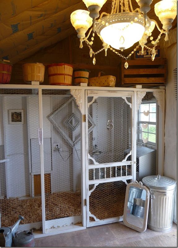 the inside of a chicken coop with several cages